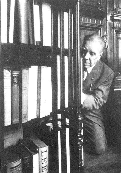 博尔赫斯蹲在地板上找书。 博尔赫斯蹲在地板上找书。